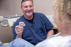 Dr Brand talking to patient about full arch dental implants Ocala , FL